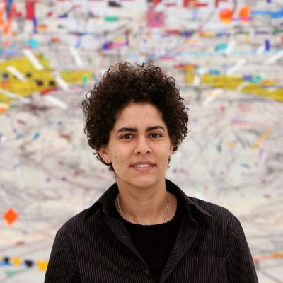 Ethiopian artist Julie Mehretu poses in front of her artwork at the Art club (Kunstverein) in Hanover, Germany, Thursday 08 February 2007. Her paintings ought to remind of satellites' images of the earth. The exhibition presents 18 large-sized works and v